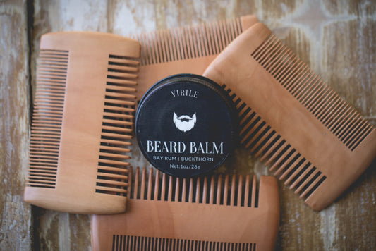 handmade beard balm scented with bay rum. Surrounded by beard combs. 