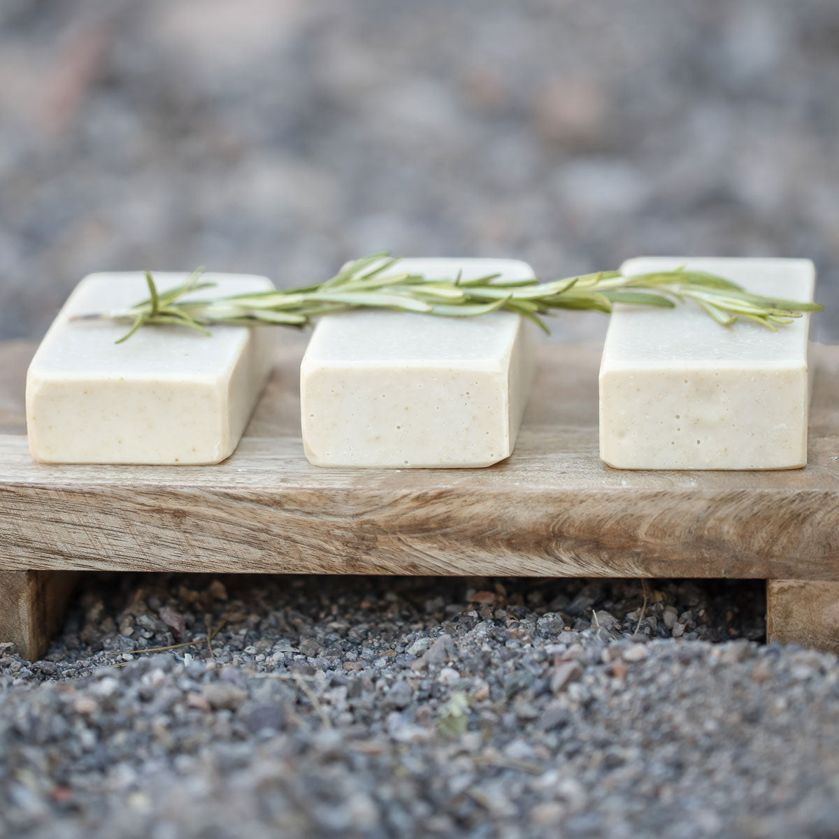 all natural bar soap with rosemary on top from the side view