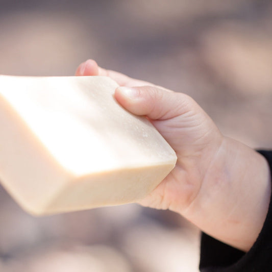 baby hand holding an all natural bar soap that is made for babies